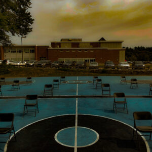 Sarah Concagh, grade 10, "Empty Chairs," digital photo, 8x10 in. Artists are continually recording and responding to the world around us. Here, Sarah has captured a moment of time at the beginning of a school year that has been unlike any other. She has used the editing tools in Photoshop to enhance the color and contrast to emphasize a specific feeling of unease and uncertainty.