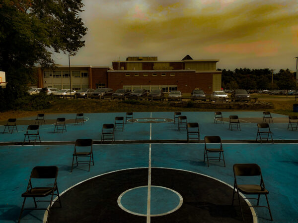 Sarah Concagh, grade 10, "Empty Chairs," digital photo, 8x10 in. Artists are continually recording and responding to the world around us. Here, Sarah has captured a moment of time at the beginning of a school year that has been unlike any other. She has used the editing tools in Photoshop to enhance the color and contrast to emphasize a specific feeling of unease and uncertainty.